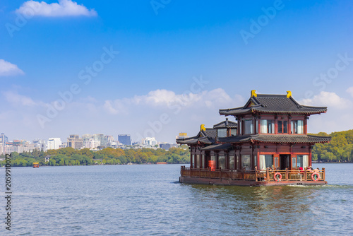 Tourist cruise boat in traditional chinese style on the West lake in Hangzhou, China