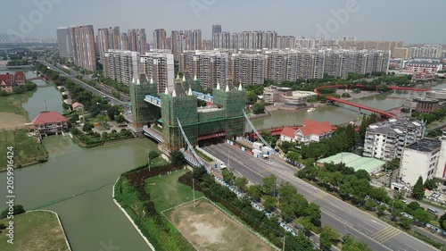 Aerial drone shot of a small replica of the London Tower Bridge under maintenance, copying global landmarks in China
