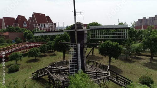 Flying past broken blades of a classic windmill built at an abandoned replica of a Dutch village in Suzhou, ghost town in China