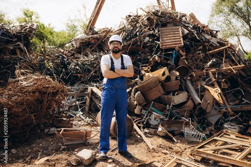 Bilde på lerret Recycling worker standing arms crossed at metal scrapyard