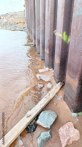 Metal Sheet Piling Seawall Along Shoreline — Coastal Infrastructure Background for Films