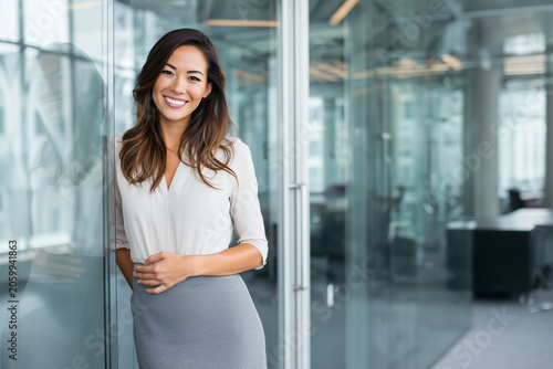 Visionary female executive manager in office, resilient businesswoman leader, smiling CEO, strategic planning wall, diverse teamwork success