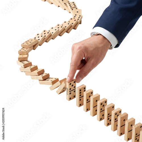 Φωτογραφία Businessman hand stopping falling wooden dominoes with stop sign