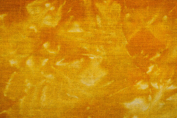 Macro view of yellow tie dye fabric texture
