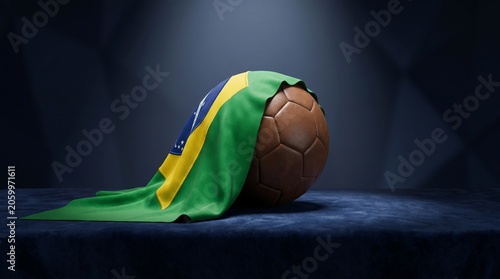 Classic leather soccer ball draped with the Brazilian flag under a spotlight