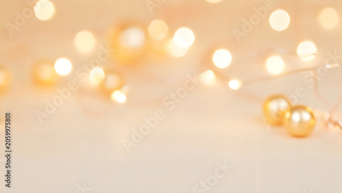 Festive golden bokeh background with warm fairy lights and copy space