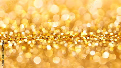 Festive gold glitter background with soft out of focus bokeh lights