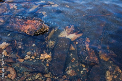 Submerged Rusty Metal Debris in Shallow Blue Water