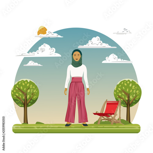 Woman in hijab standing in a park with deck chair