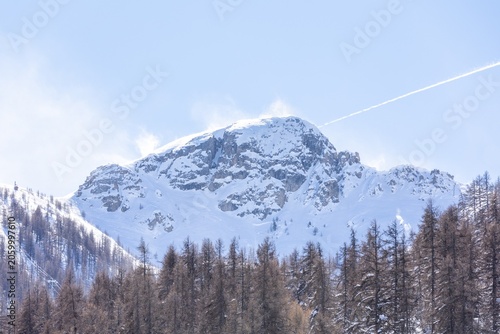 Snow-capped mountain peak under bright blue sky