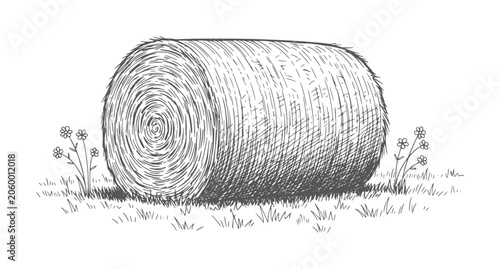 Of a round hay bale in a grassy field with small flowers monochrome black