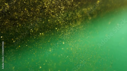 Golden glitter particles floating in a vibrant green background. Ideal for festive celebrations, creative projects, and visual storytelling