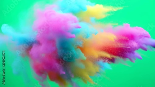 Vibrant colored powder explosion against a green background. Represents creativity, celebration, and artistic expression in various applications