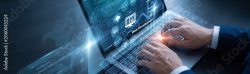 Fotografie Front-end coder is diligently managing online sites using laptop for the Web Development network protocols to ensure absolute data integration
