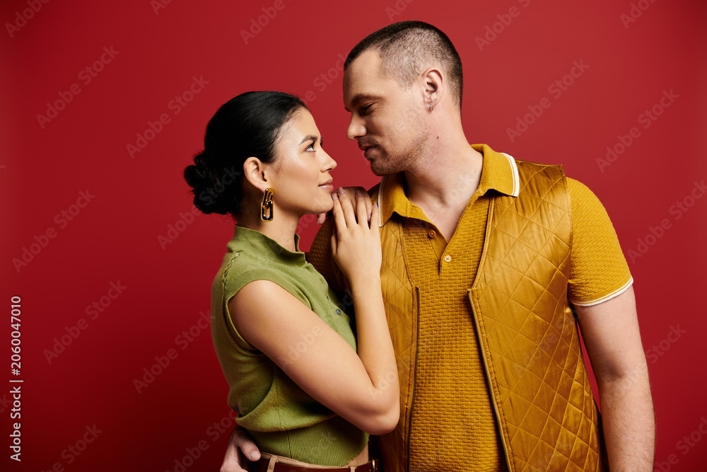 Naklejka premium A beautiful young couple in fashionable attire shares intimate moments together, celebrating love.