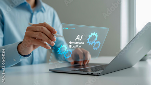 A professional business image showing a hand with a light skin tone wearing a light blue long-sleeved shirt, interacting with a holographic interface floating above a silver laptop on a white desk.