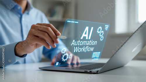 A professional business image showing a hand with a light skin tone wearing a light blue long-sleeved shirt, interacting with a holographic interface floating above a silver laptop on a white desk.