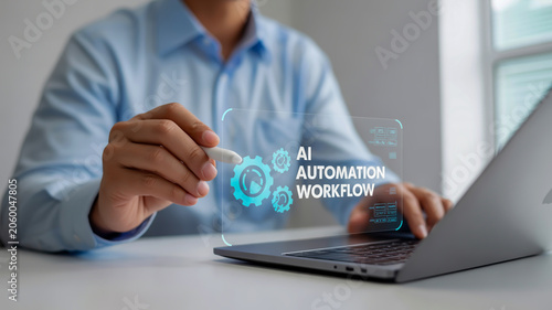 A professional business image showing a hand with a light skin tone wearing a light blue long-sleeved shirt, interacting with a holographic interface floating above a silver laptop on a white desk.