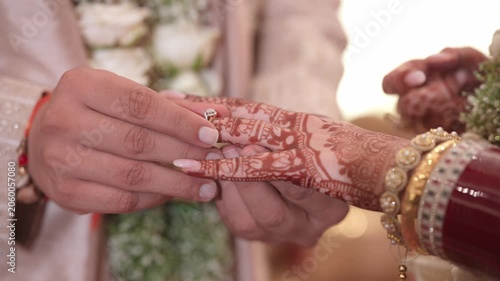 Close-up of an Indian Groom Putting a Wedding Ring on the Bride's Finger