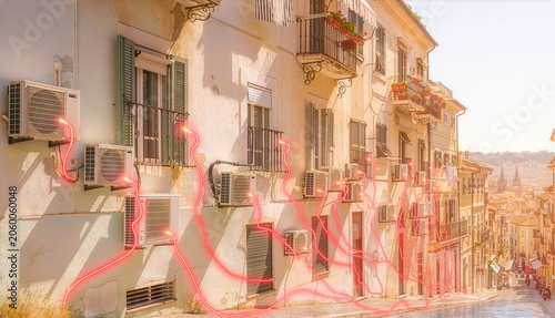 Many air conditioners running on apartment building during severe summer heat with symbolic red wires extending from windows toward distant power substation