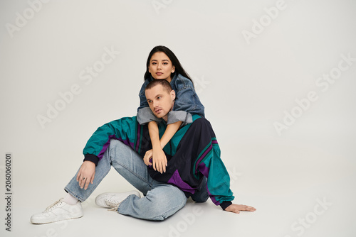 Quadro su tela A young couple poses in a stylish studio, celebrating their love and sensuality