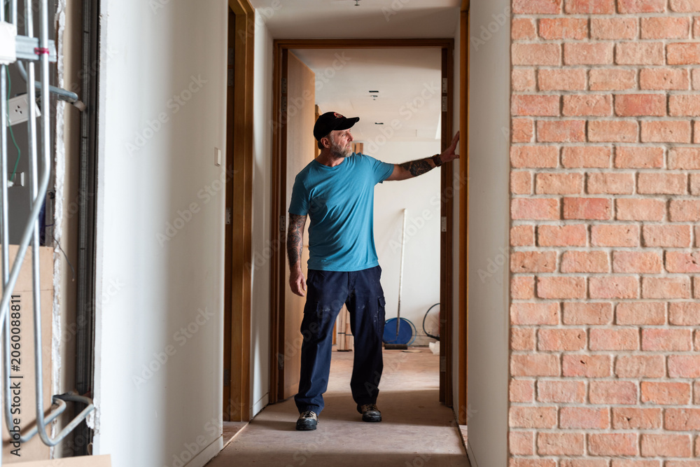 Fototapeta premium Construction worker inspecting hallway renovation