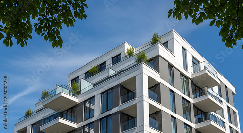 Modern building with green plants on sunny day