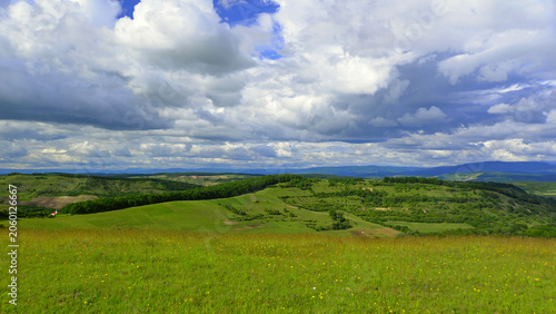 A large number of stratocumulus clouds forming over the hills on a spring day.