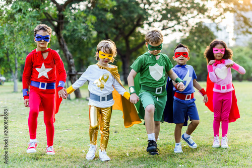 Obraz na plátně Children dressed as superheroes outdoors.