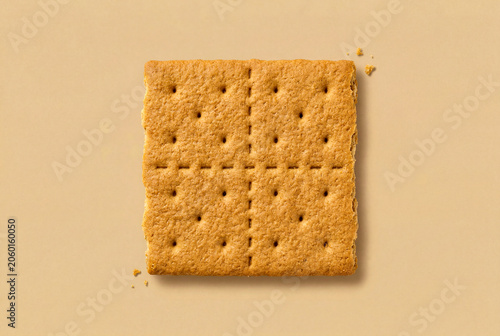 Single Graham Cracker Biscuit on Beige Surface in Flat Lay