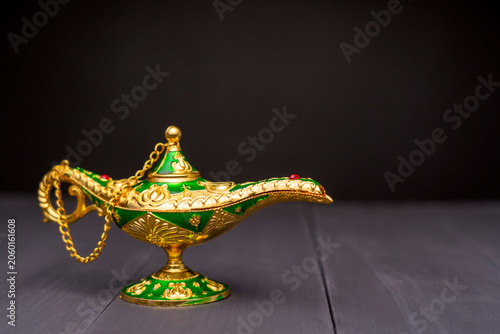 Фотография Golden magic lamp with green enamel and red gemstone