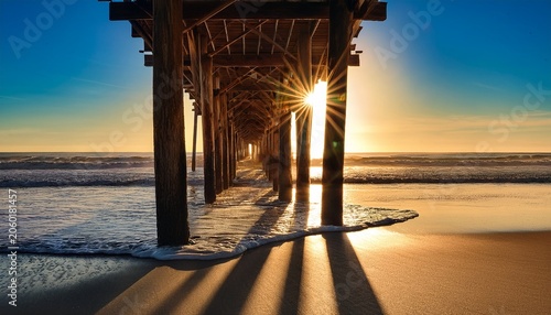 Morning Sun Shining On Underside Of Pier Along Nc Coast In Holden Beach