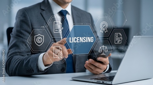 Professional interacts with a futuristic digital interface showing licensing icons and legal symbols while sitting at a desk with a laptop to manage important intellectual property and contracts.