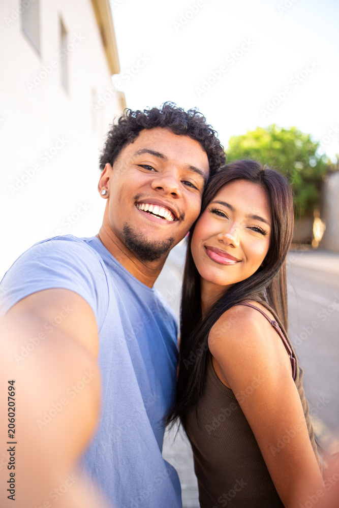Fototapeta premium Happy couple taking a close selfie in natural light