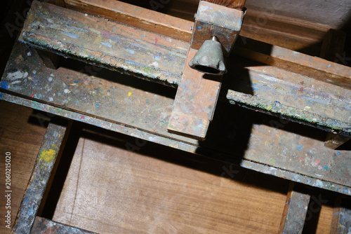 Close up of artist's easel covered in paint. Shallow depth of field