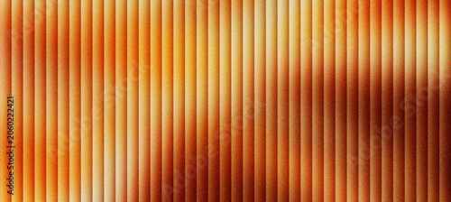 Cuadro en lienzo Abstract fluted glass texture with warm amber light, vertical ribbed glass pattern with soft orange glow, textured glass background for luxury branding, elegant architectural glass surface