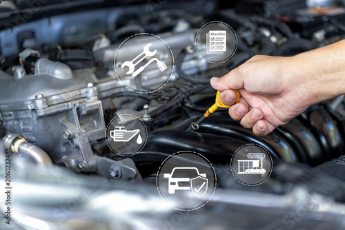 Automotive maintenance concept, Technician checking engine oil level with dipstick during vehicle inspection, preventive service, warranty coverage, and routine car care for optimal performance