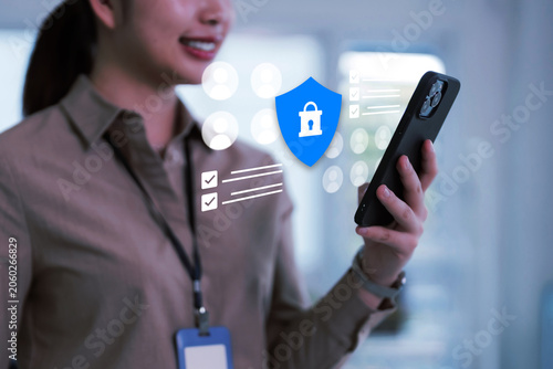 Cybersecurity and data protection concept with businesswoman using secure mobile phone and digital shield interface