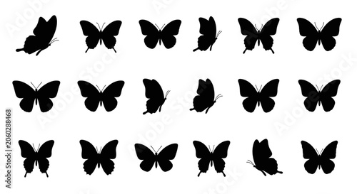 A group of butterflies are flying in the air with wings spread.