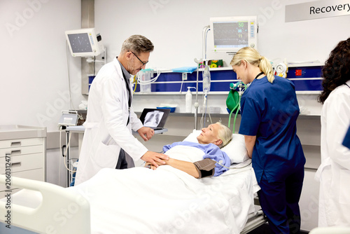 Doctor Examines Patient in Hospital Recovery Room