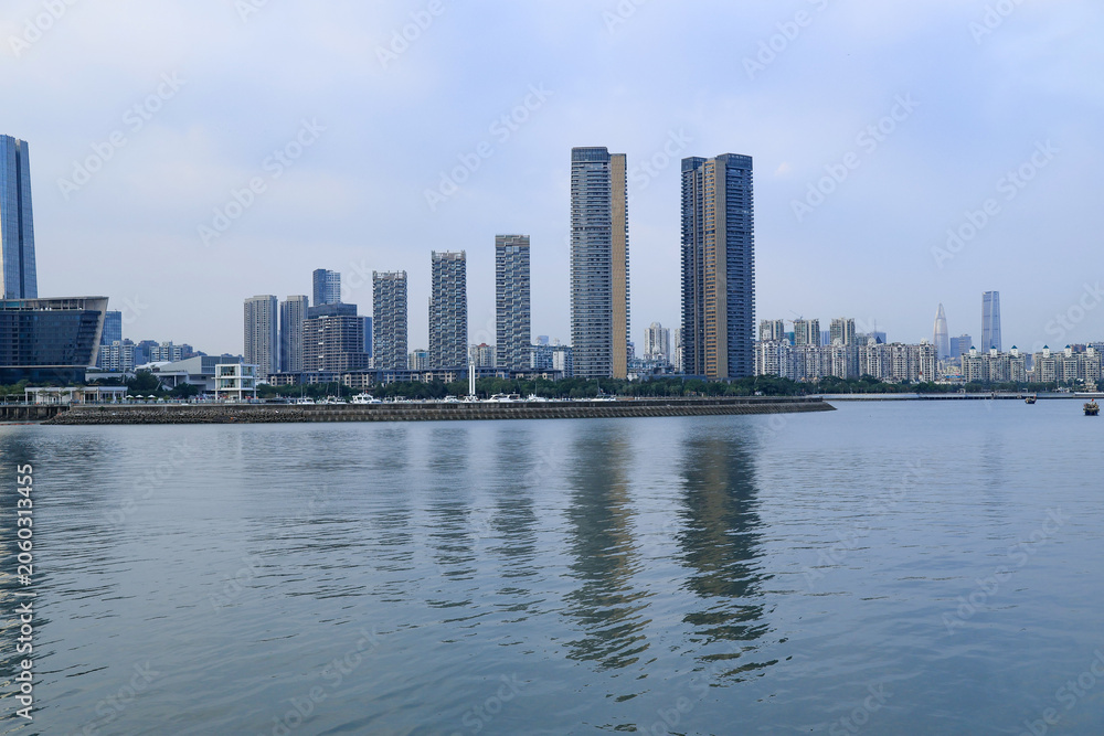 Obraz premium Modern Waterfront City Skyline with High-Rise Towers
