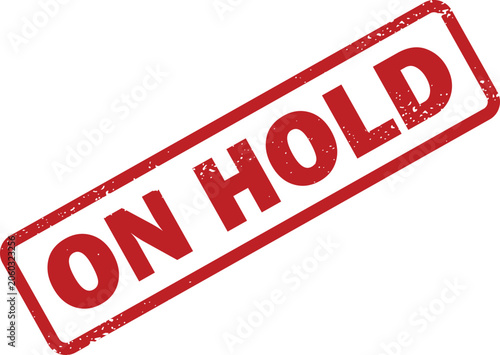 Photos Striking red rubber stamp with phrase ON HOLD indicating a temporary pause or de