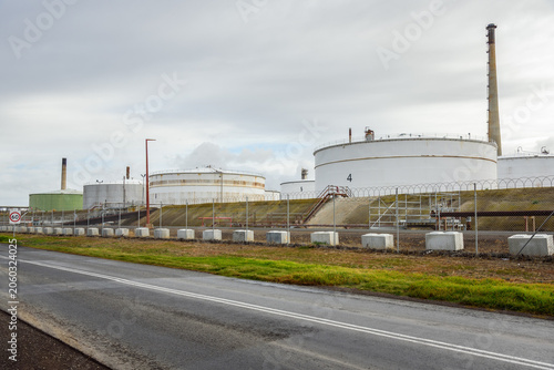 Large steel fuel tanks in a oil refinery on a cloudy autumn day