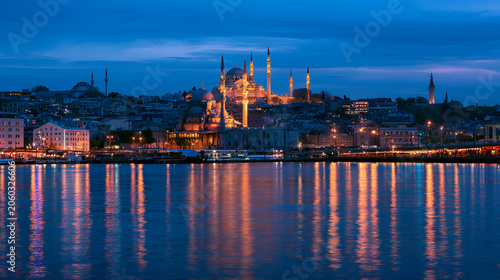 Suleymaniye mosque and istanbul skyline glow at dusk, reflected on the bosphorus and golden horn, blending ottoman architecture with vibrant waterfront city lights