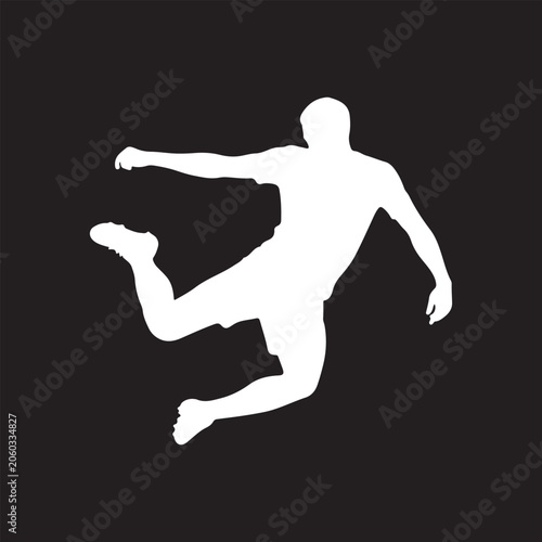 Soccer player silhouette mid-air jump against dark background with dynamic pose for sports concept