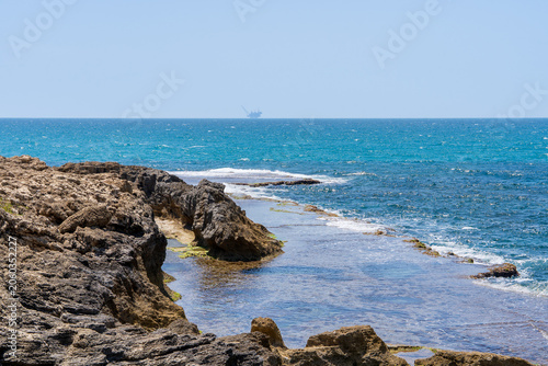 Picturesque Mediterranean coastline with turquoise waters, unique kurkar rock formations, panoramic seascapes, and rich marine biodiversity, known for its natural beauty and relaxing atmosphere.