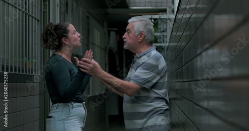 Obraz na plátně Adult daughter talking openly to elderly father outdoors expressing concern frus
