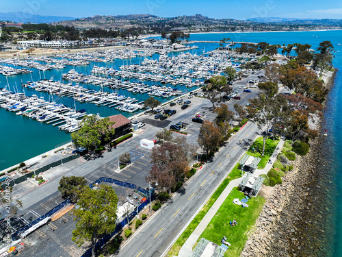 The Dana Point California  Harbor from above the Richard Henry Dana Statue using a UAV Drone looking at the harbor and the breakwaters protecting the harbor and the inlet from Pacific Oacea Waves