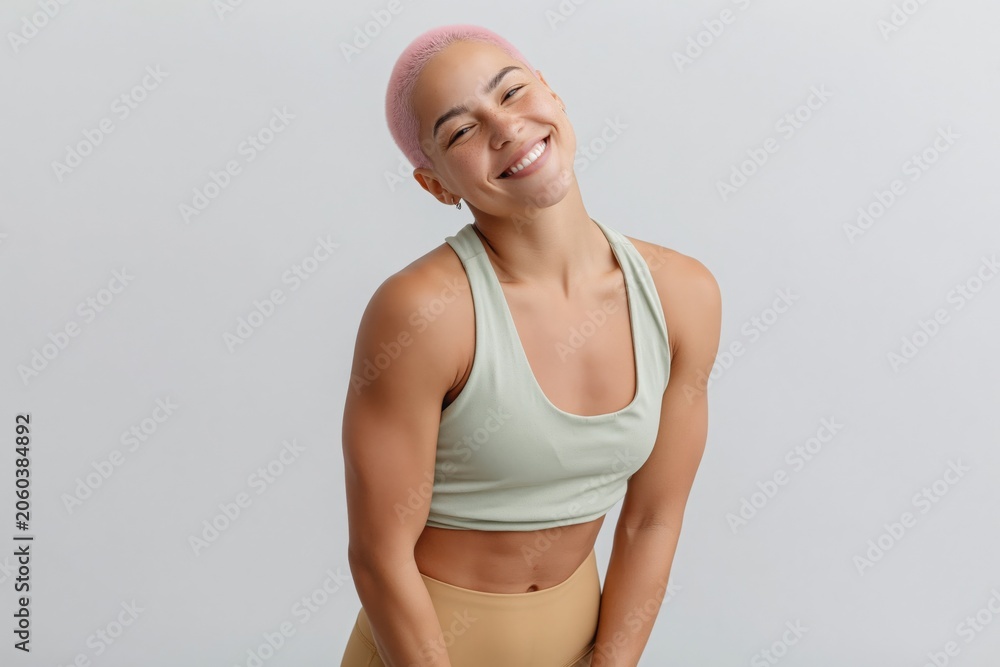 Fototapeta premium Woman with pink hair smiling and leaning in studio portrait