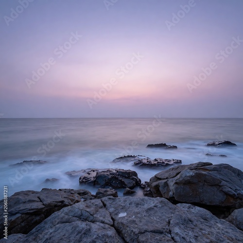 serene ocean sunset, rocky shoreline, purple pink sky, peaceful landscape, natural scenery